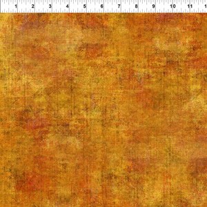 Könnte beinhalten: Ein strukturierter Stoff mit einem abgenutzten, Vintage-Look. Der Stoff ist eine Mischung aus orange, gelb und braunen Farben.