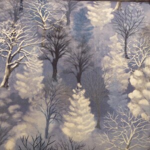 May include: Fabric featuring a winter forest scene. The design shows bare trees with snow-covered branches against a blue and white backdrop. The trees vary in size and shape, creating a textured, natural pattern.