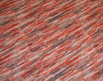 Tela patchwork con estampado gris, naranja y blanco.