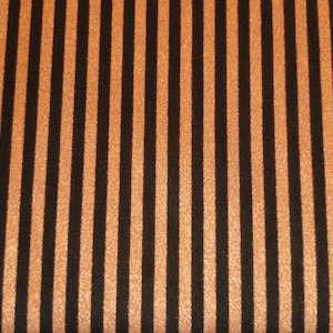 May include: Black and orange striped fabric with a subtle shimmer.