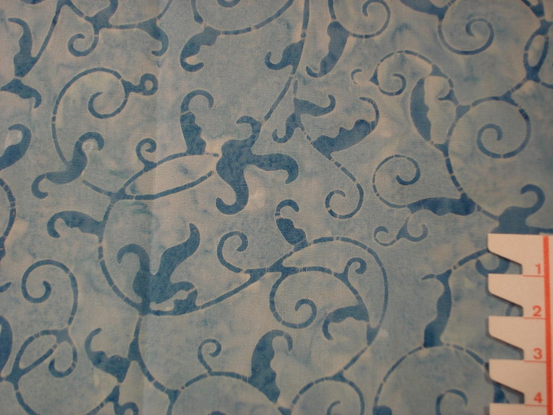 May include: Blue and white fabric with a swirling floral pattern. The fabric has a light, airy feel and would be perfect for a variety of projects.
