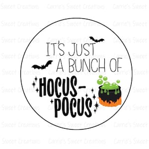 May include: A white circle with a black outline, featuring the text "It's just a bunch of Hocus-Pocus" in black. A black bat flies above the text, and a black cauldron with green bubbling liquid sits below the text. The cauldron is on a bed of orange flames.