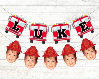 May include: A red and black fire truck themed banner with the name "LUKE" spelled out. The banner is decorated with red fire hats with a firefighter logo and a child's face in each hat.