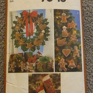 May include: Simplicity sewing pattern number 9648 for making Christmas ornaments. The pattern includes instructions for making a gingerbread wreath, a Christmas tree, and a stocking. The pattern is $2.50.
