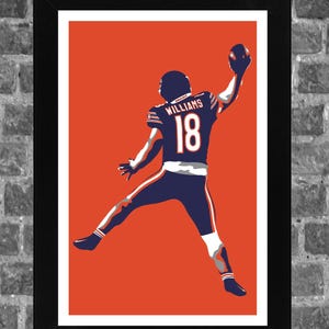 May include: Framed art print featuring a football player in a navy blue uniform with the name "WILLIAMS" and the number "18" on the back. The player is depicted mid-air, catching a football against a vibrant orange background.