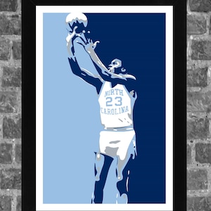 May include: A blue and white basketball poster featuring a player in a white jersey with the text "NORTH 23 CAROLINA" on the front. The player is jumping in the air and shooting a basketball.
