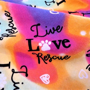 Live Love Rescue are the words that cover this special fuzzy flannel blanket with bright heirloom quality crochet edging