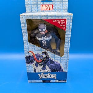 May include: A Marvel "SofVi" Series -02 Venom action figure in its original packaging. The box features the Marvel logo and multiple instances of the Marvel name. The figure is black and white with a red tongue.