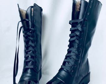 High boots fashioned for riding motorcycle army with a varnished nose and heel above the middle on a zippered lace lock  fur lacquered heel