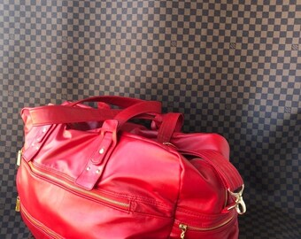 Red leather bag 60 cm wide with large zipped pockets +3 pockets inside the baglined with red raincoat fabric strong bottom and soft body bag