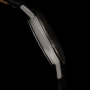 May include: Side view of a silver wristwatch with a black leather band. The watch has a rectangular face and a polished metal case. The image is set against a black background. The text "CONNOISSEUROFTIME" is visible.
