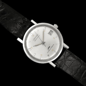 May include: A silver-toned wristwatch with a white face and black leather band. The watch face displays the date and the words "Ultra Chron" and "Automatic". The watch hands and hour markers are silver.