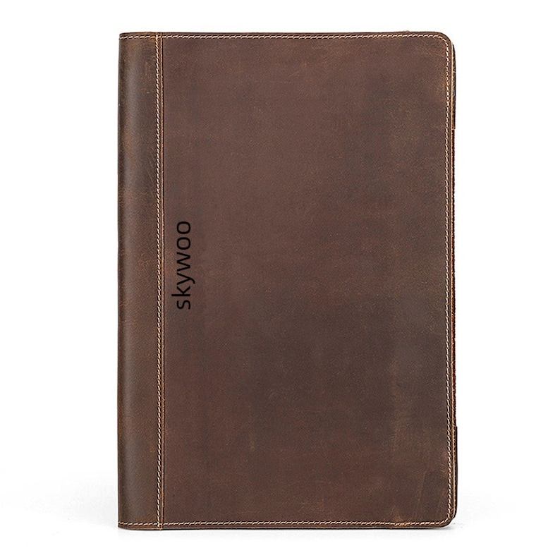 May include: A brown leather notebook with the word "skywoo" embossed on the front.