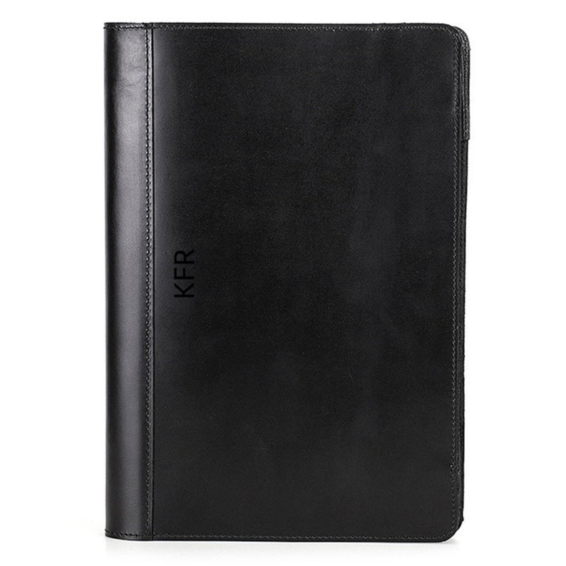 May include: Black leather binder with the initials "KFR" embossed on the front.