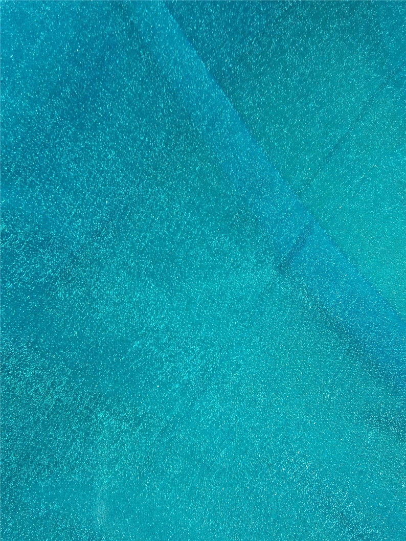 May include: A close-up of a turquoise blue surface with a subtle sparkle. The surface has a smooth, even texture.