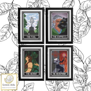 May include: Four tarot card cross stitch patterns in black frames. The cards are "The Fool", "The Empress", "The Hermit", and "The Hierophant".