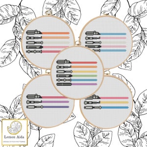 May include: Five embroidery hoops with cross stitch patterns of rainbow colored lightsabers. Each hoop has a different color combination of lightsabers.