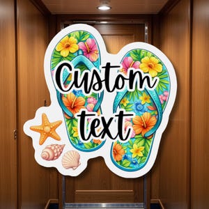 Puede incluir: Un letrero decorativo con dos chanclas adornadas con flores coloridas y el texto "Custom text". Una estrella de mar y conchas marinas también están incluidas en el diseño. Las chanclas tienen una correa turquesa y están sobre un fondo de madera.