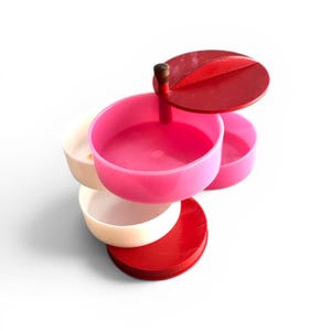 May include: A handmade, wooden cutting board with a natural finish. The board features a live edge, showcasing the wood's unique grain and shape. It is rectangular with a handle.