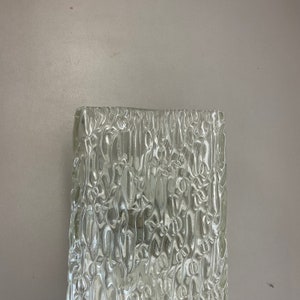 May include: Clear glass lampshade with a textured, rippled surface. The glass has a frosted appearance.