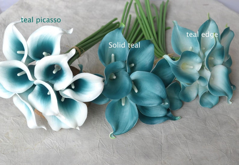 May include: Arrangement of artificial calla lilies in shades of teal and white. The flowers are grouped into bouquets with green stems. The image includes the text "teal picasso", "solid teal", and "teal edge".