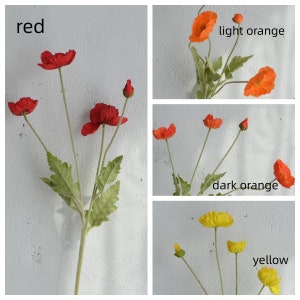 May include: Four stems of artificial poppy flowers in red, light orange, dark orange, and yellow. The flowers are arranged in a bouquet and have green leaves.