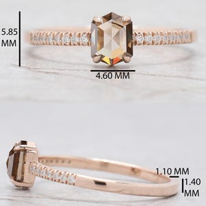 Op de afbeelding: Ros&eacute;gouden ring met een zeshoekige, lichtbruine edelsteen, met een afmeting van 5,85 mm x 4,60 mm. De band is bezet met kleine, heldere stenen. De ringband is 1,10 mm tot 1,40 mm dik. Close-up die het ontwerp en de details benadrukt.