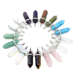 May include: Assortment of 18 silver-toned crystal point pendants with various gemstone colors, including green, blue, purple, pink, white, and brown. Each pendant features a silver-toned bail.