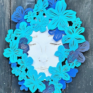 Arte de colagem de papel “Rosto&quot;. Corte de papel original, arte recortada Silhueta de uma guirlanda, flores, ao redor do rosto da menina. Decoração decorativa de parede