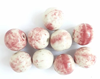 A set of 9 handmade ceramic beads. Round beads hand-glazed in a pink blush. 18mm x 19mm.