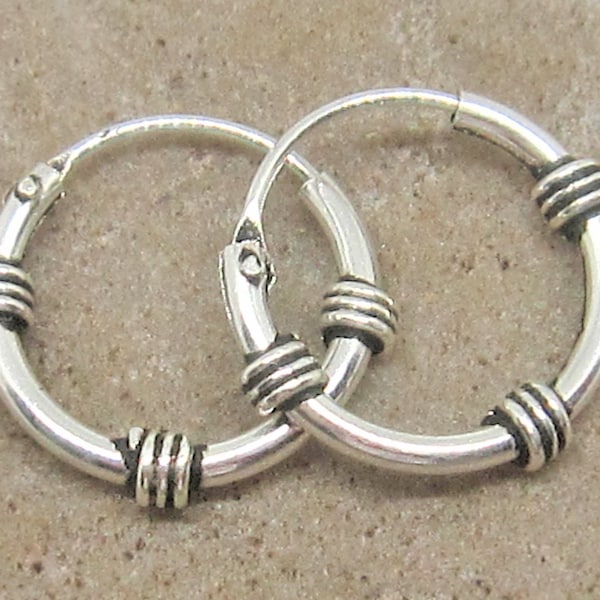 Handmade sterling silver Bali hoop earrings. Very small earings some customers have used them for helix piercings. 10mm.
