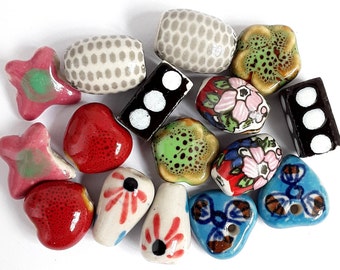 16 Handmade ceramic beads. 8 pairs of handmade ceramic beads. 16 beads. Measuring 5mm - 18mm.