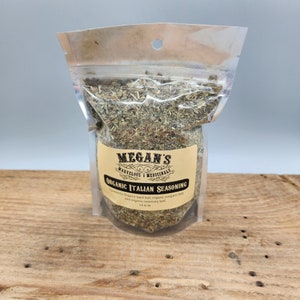 A clear resealable bag filled with dried herbs labeled "MEGAN'S MARVELOUS MEDICINALS ORGANIC ITALIAN SEASONING". The ingredients are listed as "organic basil leaf, organic oregano leaf, and organic rosemary leaf".