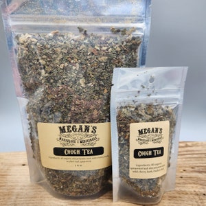 May include: Two clear plastic pouches filled with dried herbs labeled "Megan's Cough Tea." The larger pouch contains 2 fl oz. The ingredients listed are organic elecampane root, wild cherry bark, mullein leaf, and spearmint.