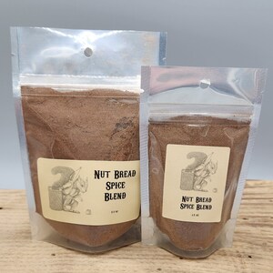 May include: Two clear plastic bags filled with brown spice blend. The larger bag has a label that reads "Nut Bread Spice Blend 2.5 oz". The smaller bag has a label that reads "Nut Bread Spice Blend 1.5 oz".