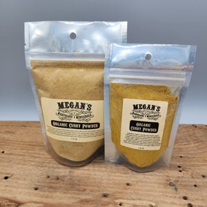 May include: Two clear plastic pouches containing organic curry powder. The pouches are labeled "Megan's Marvelous Medicinals" and "Organic Curry Powder".