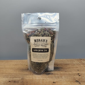 “Close up of milk thistle seeds and rosehips in loose leaf tea blend”