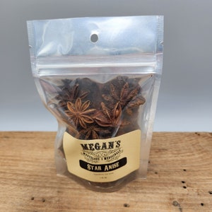A clear plastic bag filled with brown star anise. The bag has a label that reads "Megan's Marvelous Medicinals Star Anise".