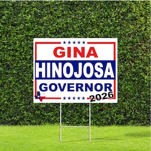 May include: A rectangular political yard sign with a white background, red border, and blue horizontal stripe. It features the red text GINA, blue text HINOJOSA, and blue text GOVERNOR. Includes a small Texas state map icon and the black text 2026.