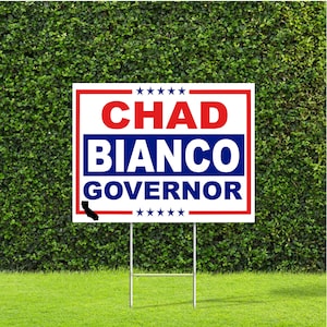 May include: A white and red political yard sign with blue text that reads "Chad Bianco Governor" with a black silhouette of the state of California in the bottom left corner.