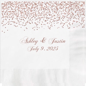 May include: White paper napkin with a rose gold confetti design and the text "Ashley & Justin July 9, 2025".
