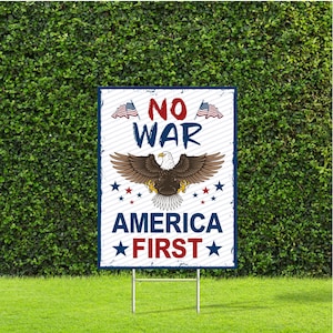 May include: A rectangular sign with the words "NO WAR" in red and blue, and "AMERICA FIRST" in red. An eagle with outstretched wings is centered below the words "NO WAR". Two American flags are at the top.