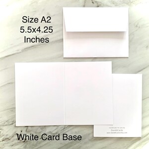 May include: A collection of white A2 size card bases and an envelope. The card base measures 5.5 x 4.25 inches. The text "White Card Base" is displayed at the bottom of the image. The image also includes the text "Size A2 5.5x4.25 Inches".
