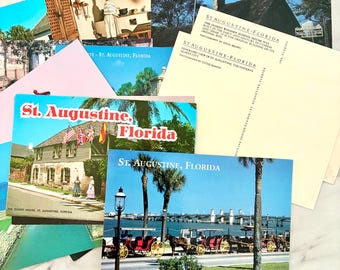 May include: A collection of vintage postcards featuring scenes from St. Augustine, Florida. The postcards showcase historical buildings, horse-drawn carriages, and palm trees, with text that reads "St. Augustine, Florida."