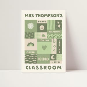 May include: A rectangular poster with a cream background featuring the text MRS THOMPSON'S CLASSROOM in sage green. The center contains a grid of sage green and cream squares with icons like a clover, smiley face, rainbow, heart, and moon, plus words including BRAVE, RESPECTFUL, LOVING, STRONG, CLEVER, KIND, and JOYFUL.