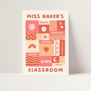 May include: A rectangular poster titled MISS BAKER'S CLASSROOM featuring a grid of squares and rectangles in shades of pink, red, and cream. The design includes icons like a flower, smiley face, stars, rainbow, heart, and moon, with words like BRAVE, RESPECTFUL, LOVING, STRONG, CLEVER, KIND, and JOYFUL.