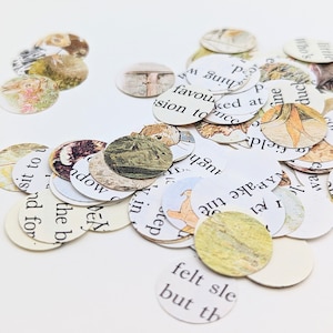 May include: A collection of small, round paper cutouts scattered across a white surface. Each cutout features illustrations and text from a vintage book, with soft colors and a whimsical aesthetic. The cutouts vary in size and are ideal for crafting.