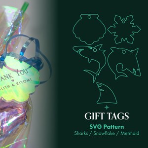 May include: A gift bag with iridescent wrapping and a scalloped tag that says "Thank You" with the names Lilith & Kiyomi. The image also shows SVG pattern gift tags with shark, snowflake, and mermaid designs.