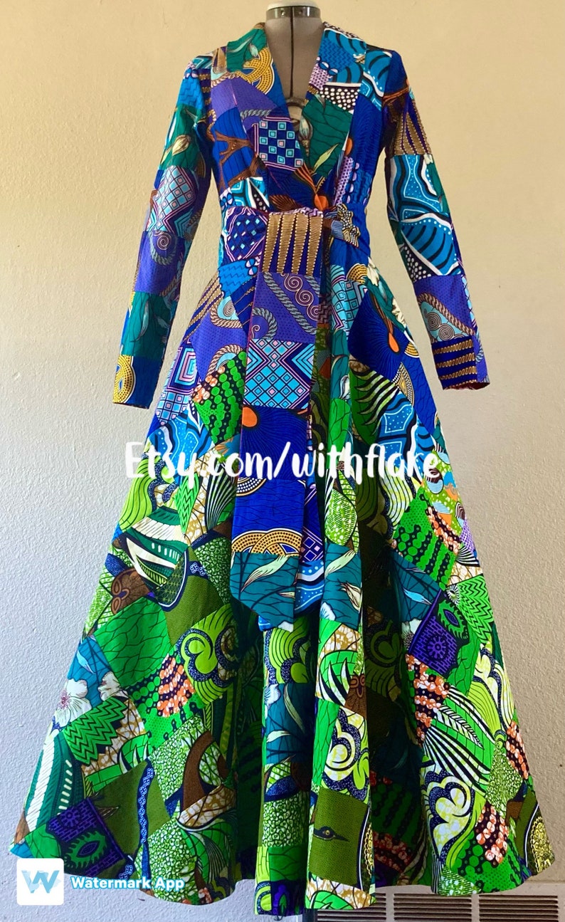 May include: A long-sleeved dress with a patchwork design featuring a variety of colors and patterns, including blue, green, purple, and orange. The dress has a V-neckline and a tie at the waist. The dress is made of fabric with a geometric pattern. The dress is on a mannequin. The text "Etsy.com/withflake" is visible on the dress.