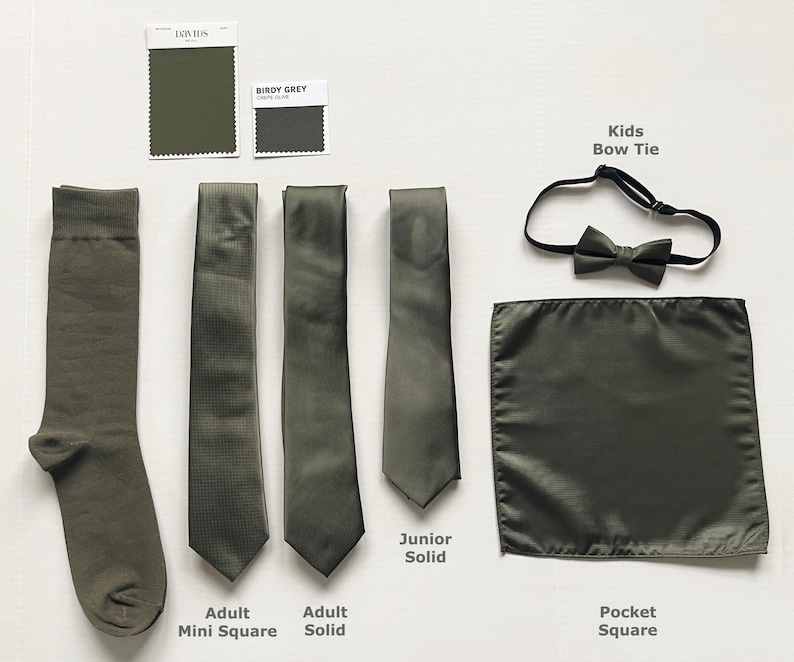 May include: Olive green formal wear accessories including a sock, ties, bow tie, and pocket square. The ties are labeled "Adult Mini Square", "Adult Solid", and "Junior Solid". A "Kids Bow Tie" and "Pocket Square" are also shown. Color swatches are included.